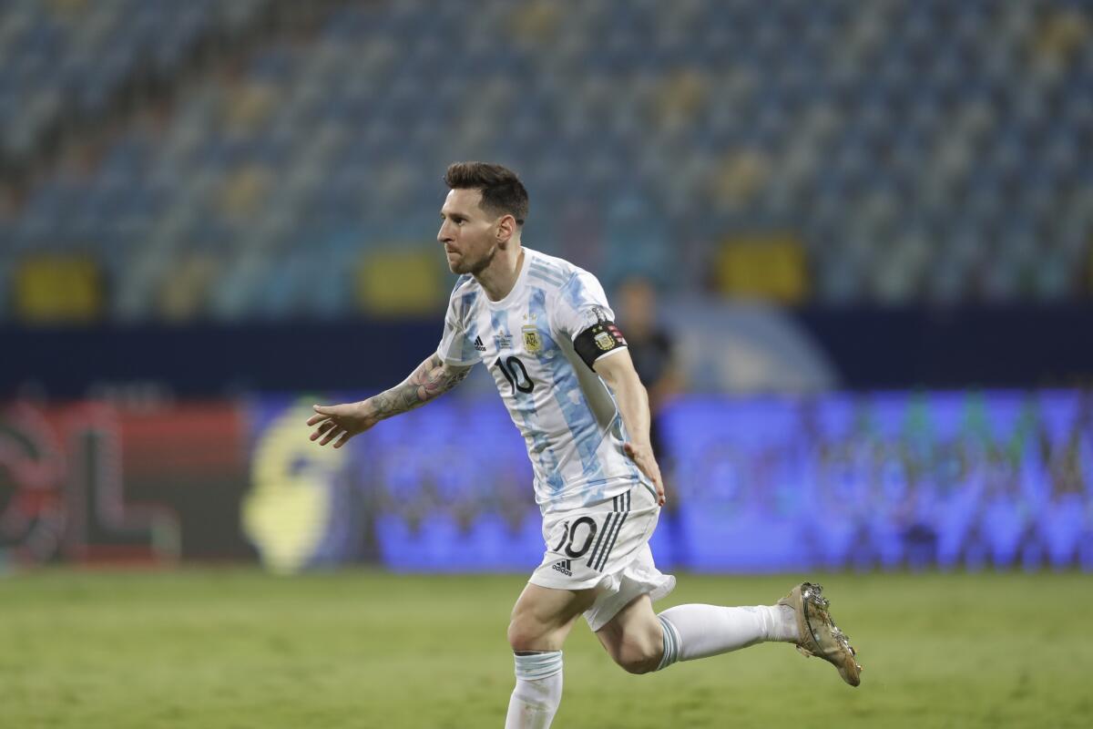 Argentina's Lionel Messi celebrates scoring his side's third goal against Ecuador during a Copa America quarterfinal soccer match at the Olimpico stadium in Goiania, Brazil, Saturday, July 3, 2021. (AP Photo/Andre Penner)