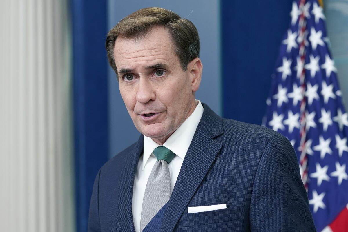 National Security Council spokesman John Kirby speaks while standing in front of a U.S. flag.