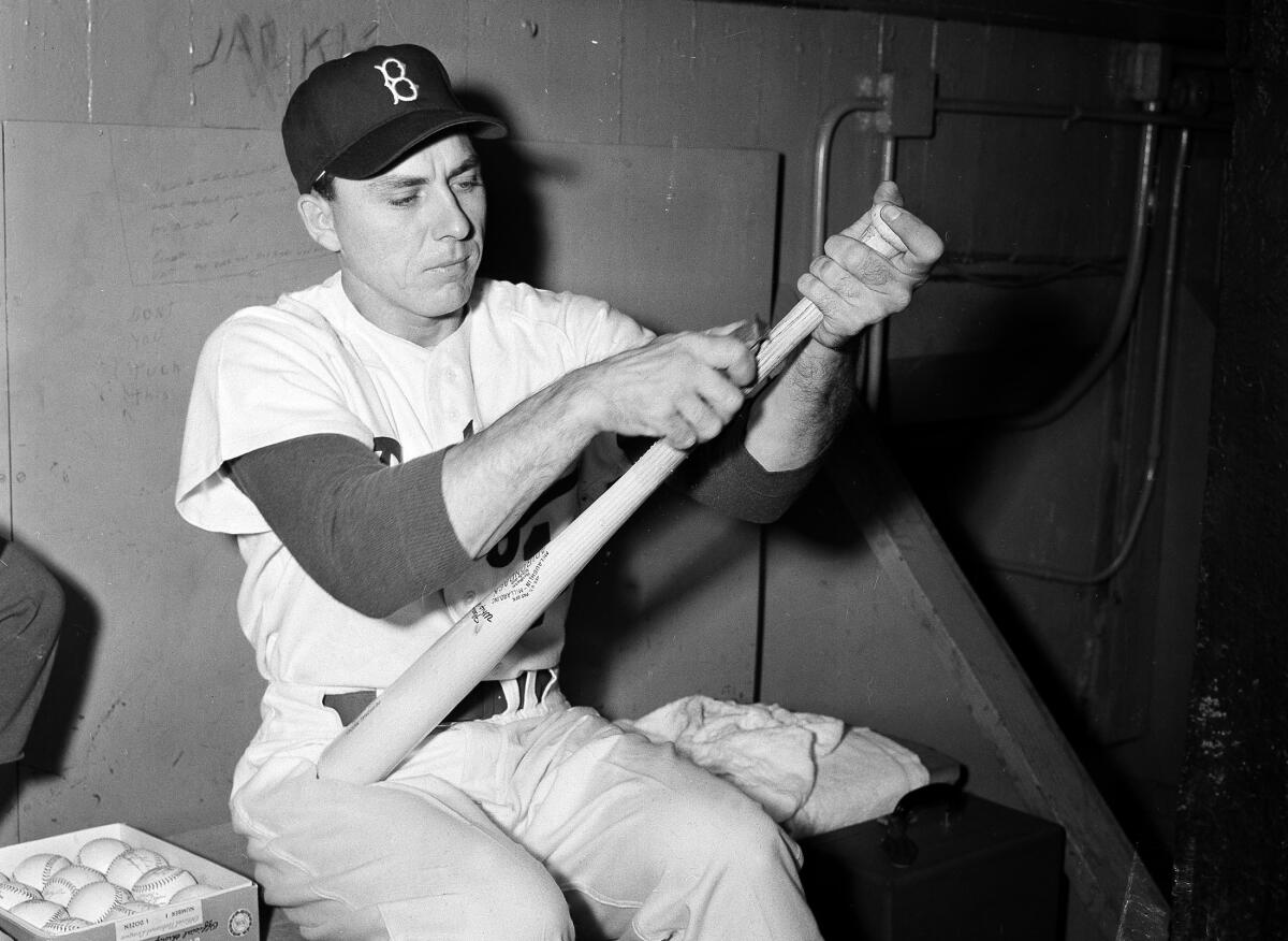 Brooklyn Dodgers' first baseman Gil Hodges shaves a new bat in New York, Oct. 1, 1952.