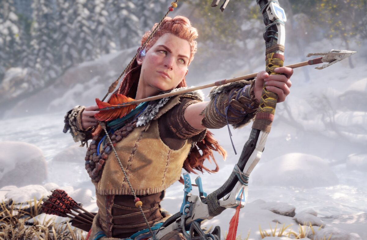 In a still image from a video game, a woman warrior aims a bow and arrow.