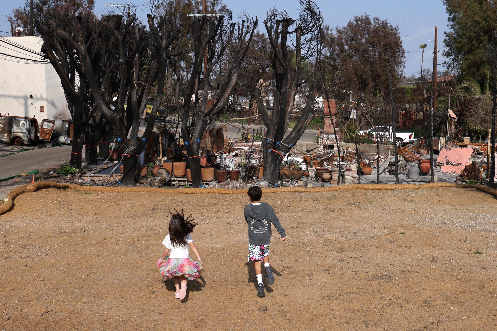 Mandana and Justin Sisco, visit the site where their home once stood with their children in Pacific Palisades on April.