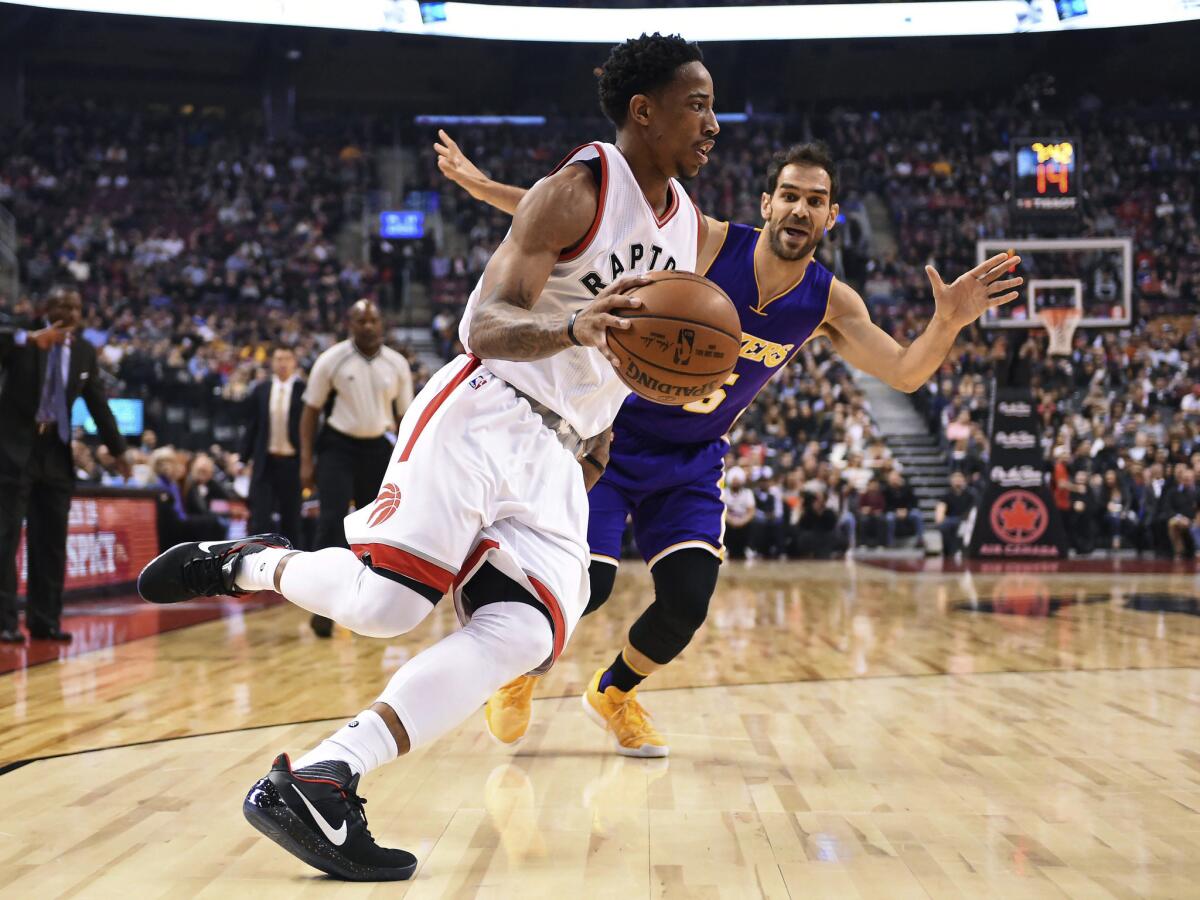 Raptors guard DeMar DeRozan drives past Lakers point guard Jose Calderon during the first half of Saturday's game.