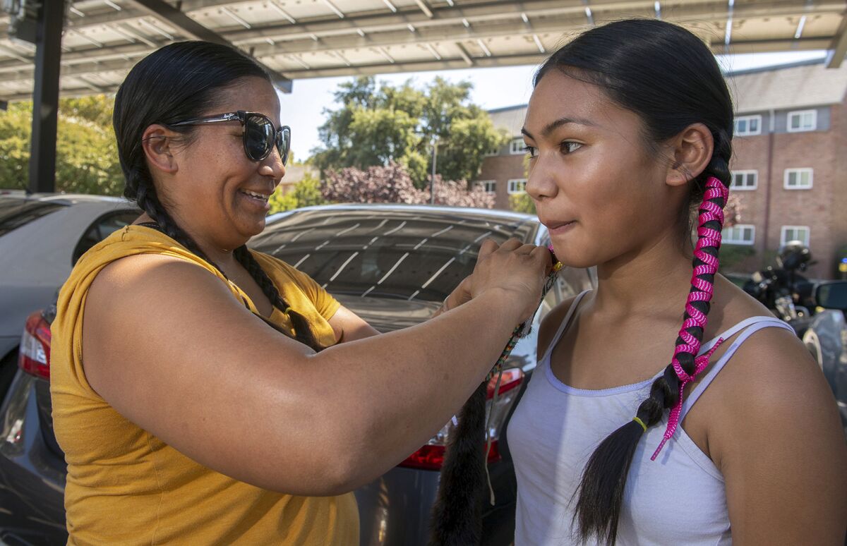 Ruby Carino helps her 13-year-old daughter Nova get ready for the annual Labor Day Stockton Community Pow Wow in Stockton on Saturday, August 3, 2022. Photo by Clifford Oto, The Stockton Record via Reuters