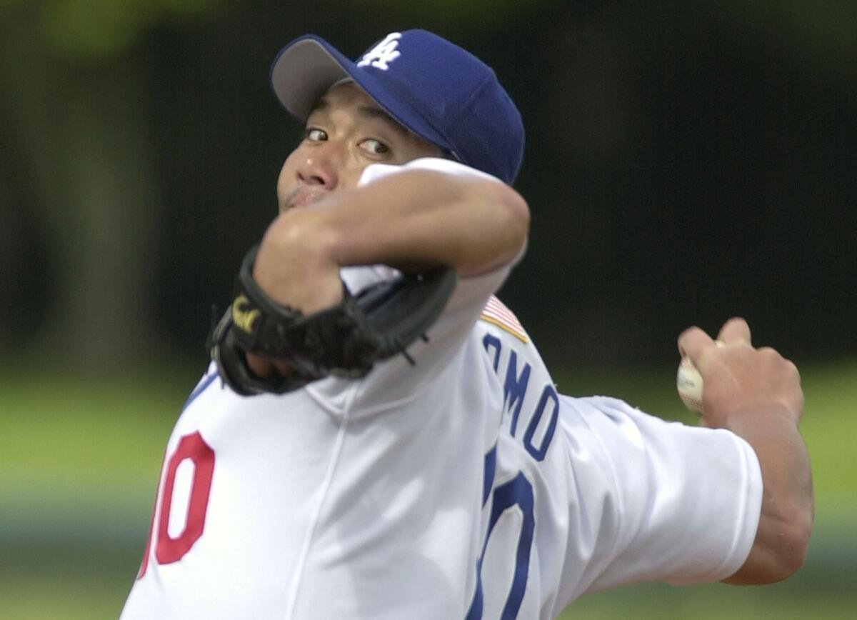 Dodgers pitcher Hideo Nomo warms up before pitching against the Florida Marlins in a 2002 exhibition game.