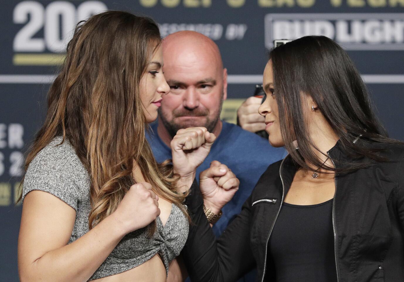 Miesha Tate, left, and Amanda Nunes pose for photographers during a UFC 200 mixed martial arts news conference, Wednesday, July 6, 2016, in Las Vegas. The two are scheduled to fight in a women's bantamweight championship fight at UFC 200 on Saturday. (AP Photo/John Locher)