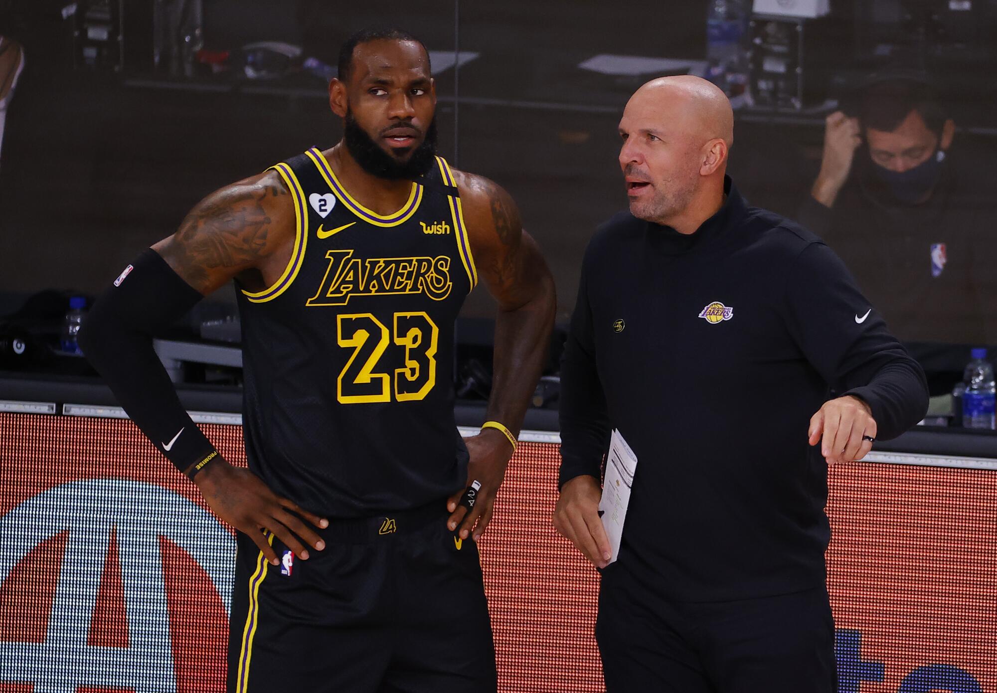 Lakers star LeBron James, left, talks with Jason Kidd during a playoff game against the Portland Trail Blazers.