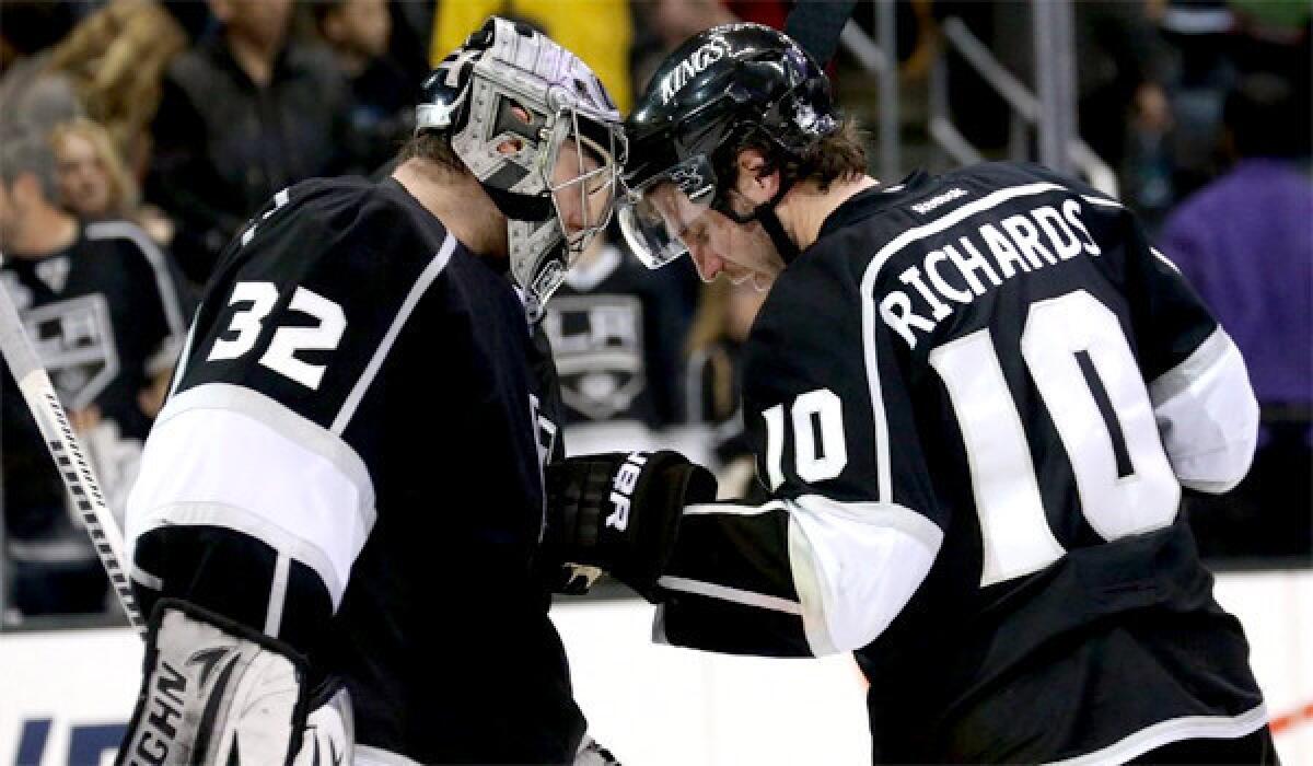 Jonathan Quick and Mike Richards celebrate a 2-1 victory over the Anaheim Ducks on April 13, 2013.