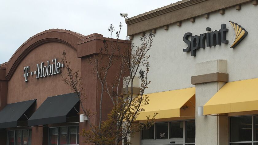 T-Mobile and Sprint stores sit side by side in a strip mall last year.