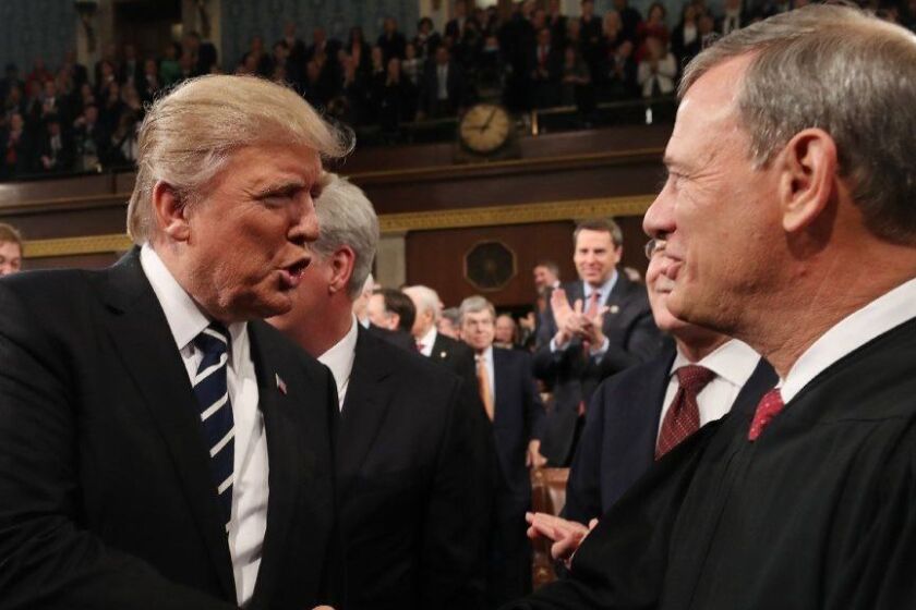 (FILES) In this file photo taken on February 28, 2017, US President Donald Trump (L) shakes hands with US Supreme Court Chief Justice John Roberts (R) as Trump arrives to deliver his first address to a joint session of Congress in Washington, DC. - Chief Justice Roberts issued an extraordinary rebuke of Trump on November 21, 2018, after the president criticized a ruling he said was handed down by an "Obama judge." "We do not have Obama judges or Trump judges, Bush judges or Clinton judges," Roberts said in a statement to the Associated Press. "What we have is an extraordinary group of dedicated judges doing their level best to do equal right to those appearing before them," Roberts said. (Photo by JIM LO SCALZO / POOL / AFP)JIM LO SCALZO/AFP/Getty Images ** OUTS - ELSENT, FPG, CM - OUTS * NM, PH, VA if sourced by CT, LA or MoD **