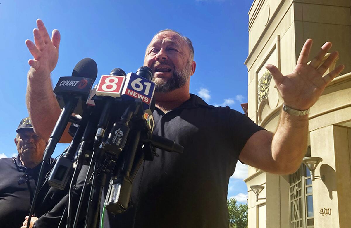 Alex Jones addresses the media outside a courthouse in Waterbury, Conn., on Sept. 21.