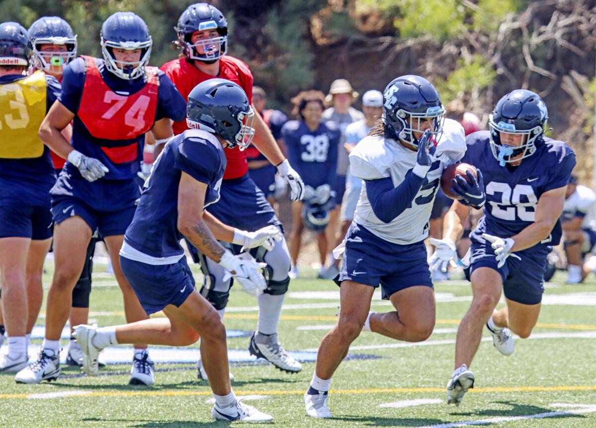 USD players run through drills during last week's practice on campus.