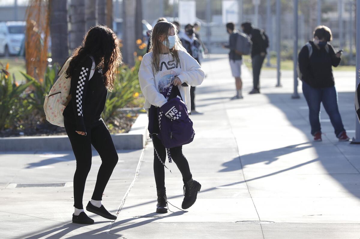 Students return to Costa Mesa High school on the first day back to school.