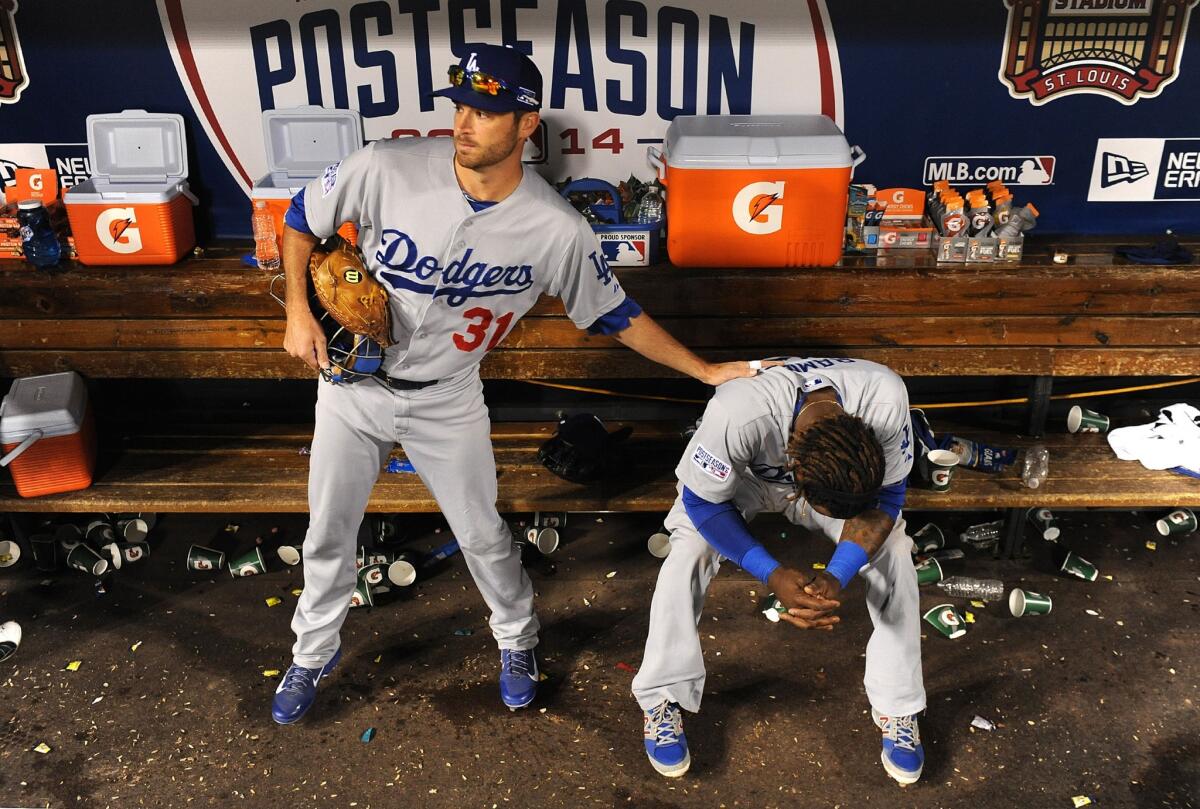 Catcher Drew Butera consoles shortstop Hanley Ramirez after the Dodgers were eliminated from the playoffs with a 3-2 loss to the Cardinals in Game 4 of the National League Division Series.
