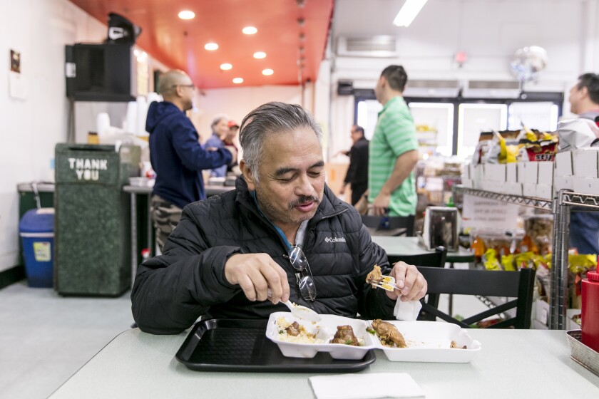 Ted Robles enjoys his weekly turo turo breakfast of chicken adobo and an egg at Greenhills Market & Fast Food.