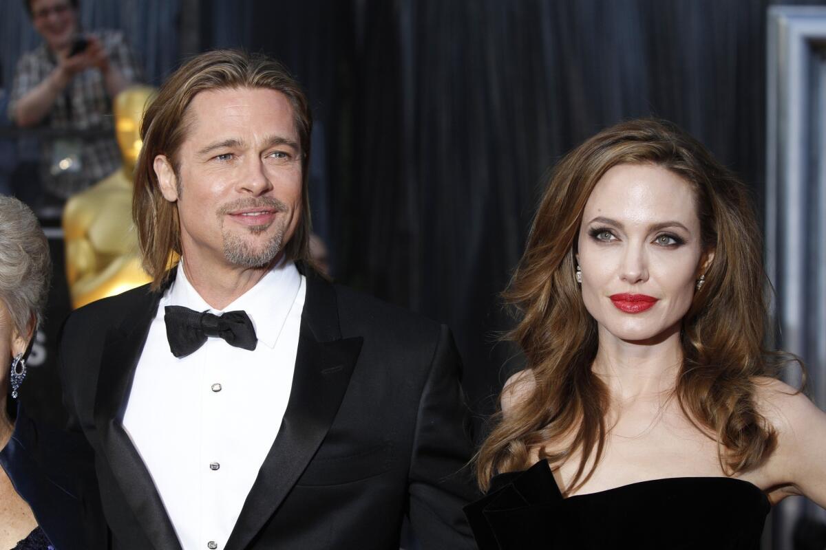 Brad Pitt and Angelina Jolie at the 84th Annual Academy Awards show. Jolie admitted that her kids like to eat fried crickets for a snack.
