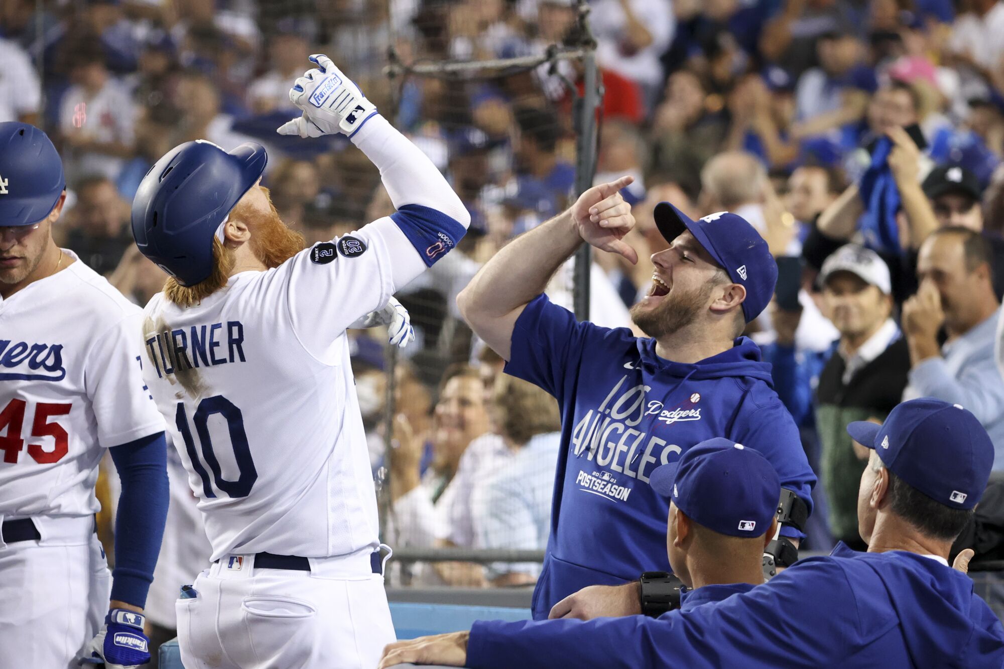Los Angeles Dodgers' Justin Turner, left, celebrates with Max Muncy after hitting a solo home run