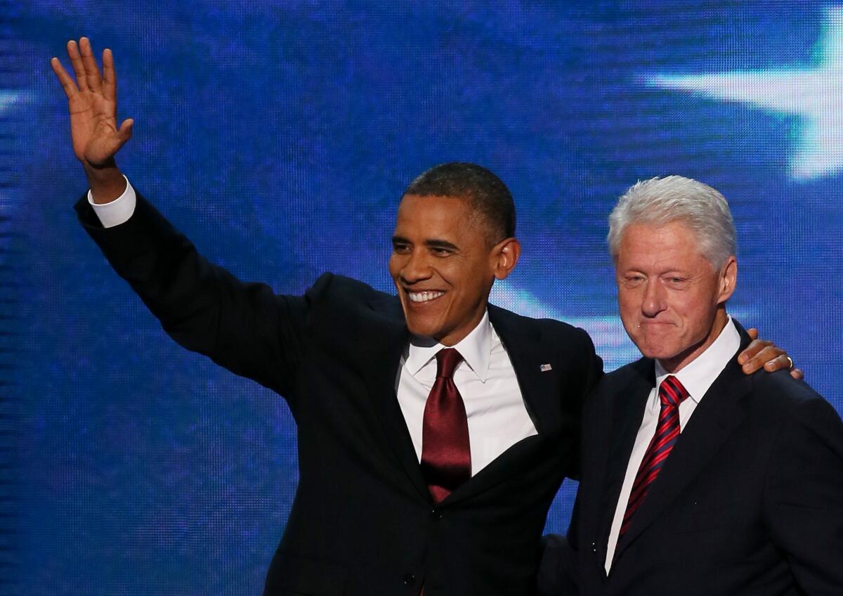 President Obama and former President Clinton on stage together after Clinton's speech at the Democratic National Convention.