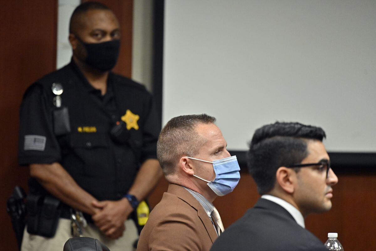 Former Louisville Police officer Brett Hankison, center, awaits the juries verdict in his wanton endangerment trial, Thursday, March 3, 2022, in Louisville, Ky. The jury cleared Hankison of charges that he endangered neighbors when he fired shots into an apartment during the 2020 drug raid that ended with Breonna Taylor’s death. (AP Photo/Timothy D. Easley, Pool)