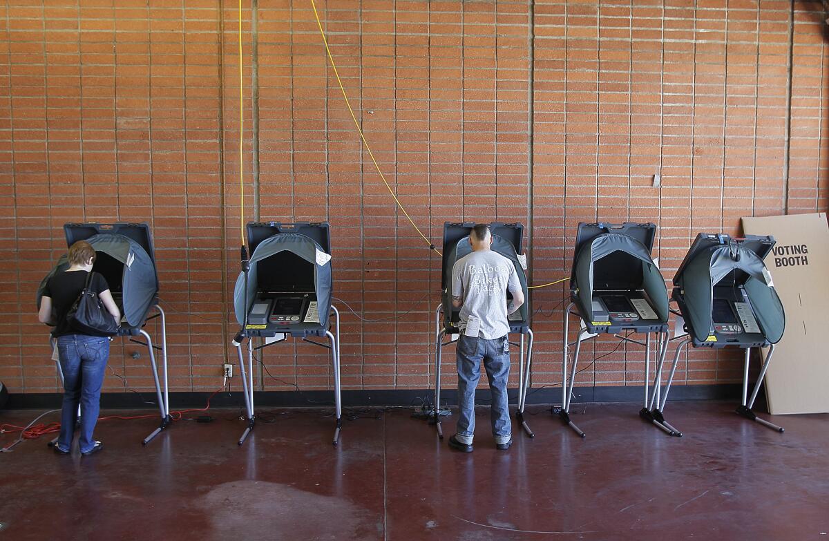 Newport Beach residents cast their ballots at Balboa Peninsula Fire Station No. 1 in 2012. Development and the unfunded pension liability are key issues in this year's race.