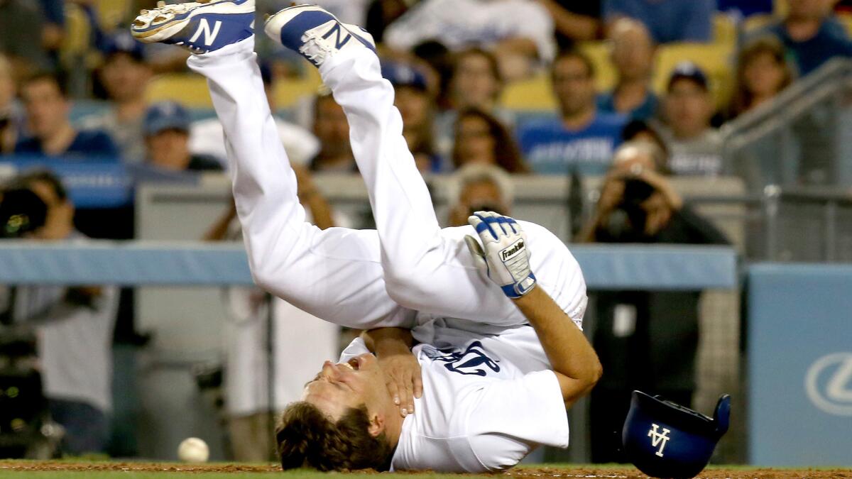 Rich Hill falls to the ground after getting hit by a pitch from Padres starter Clayton Richard during the fourth inning Friday.