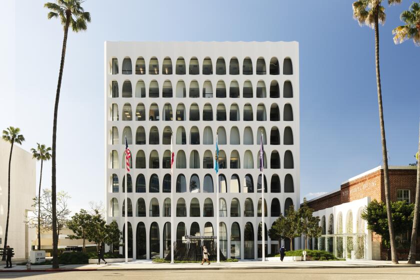 An office tower fronting a small plaza is composed of eight rows of bright Modern symmetrial arches 