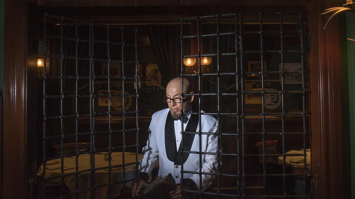 Bartender Louis Poblano locks up the Dining Car's bar section, the Club Car, at 2 a.m. Poblano has worked at the restaurant since 1989.