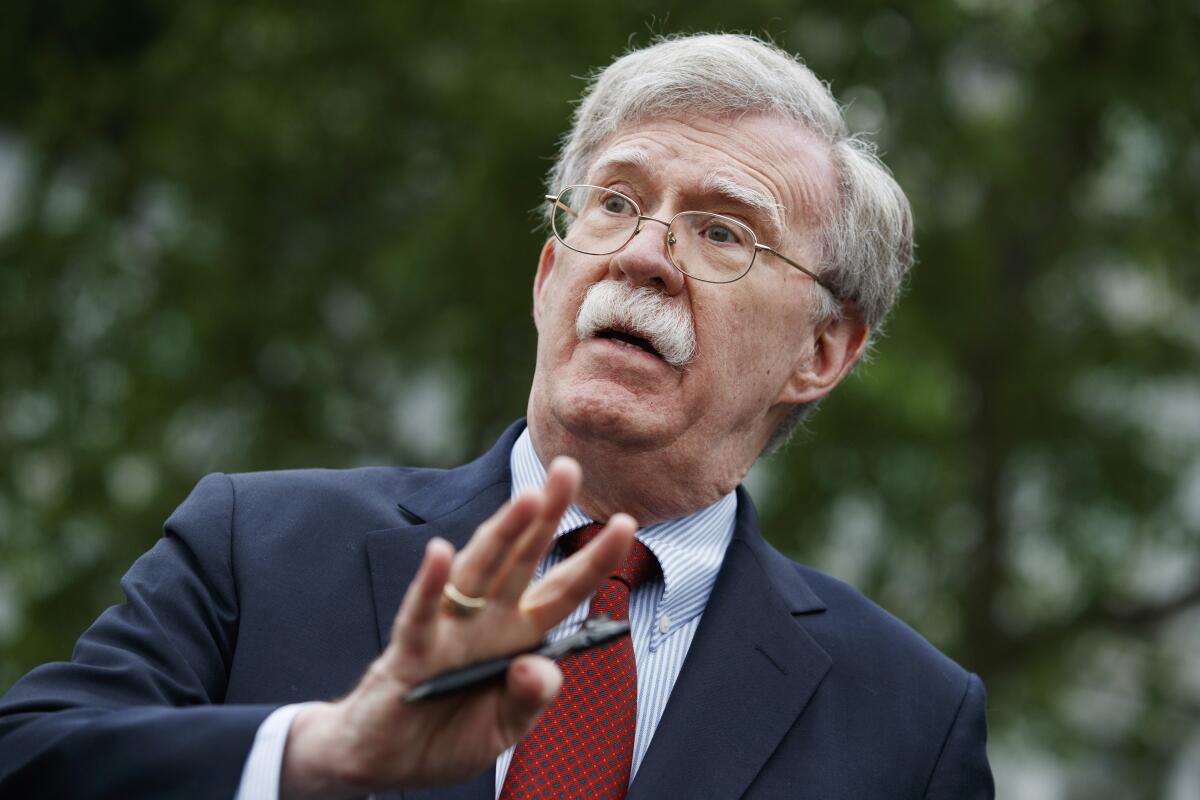 John Bolton talks to reporters outside the White House on May 1.