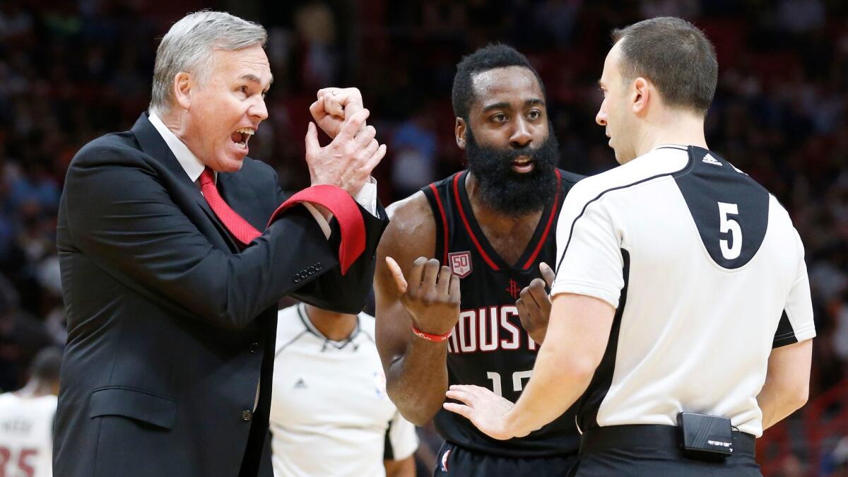 Houston Coach Mike D'Antoni, left, and guard James Harden argue a call with official Kane Fitzgerald on Jan. 17.