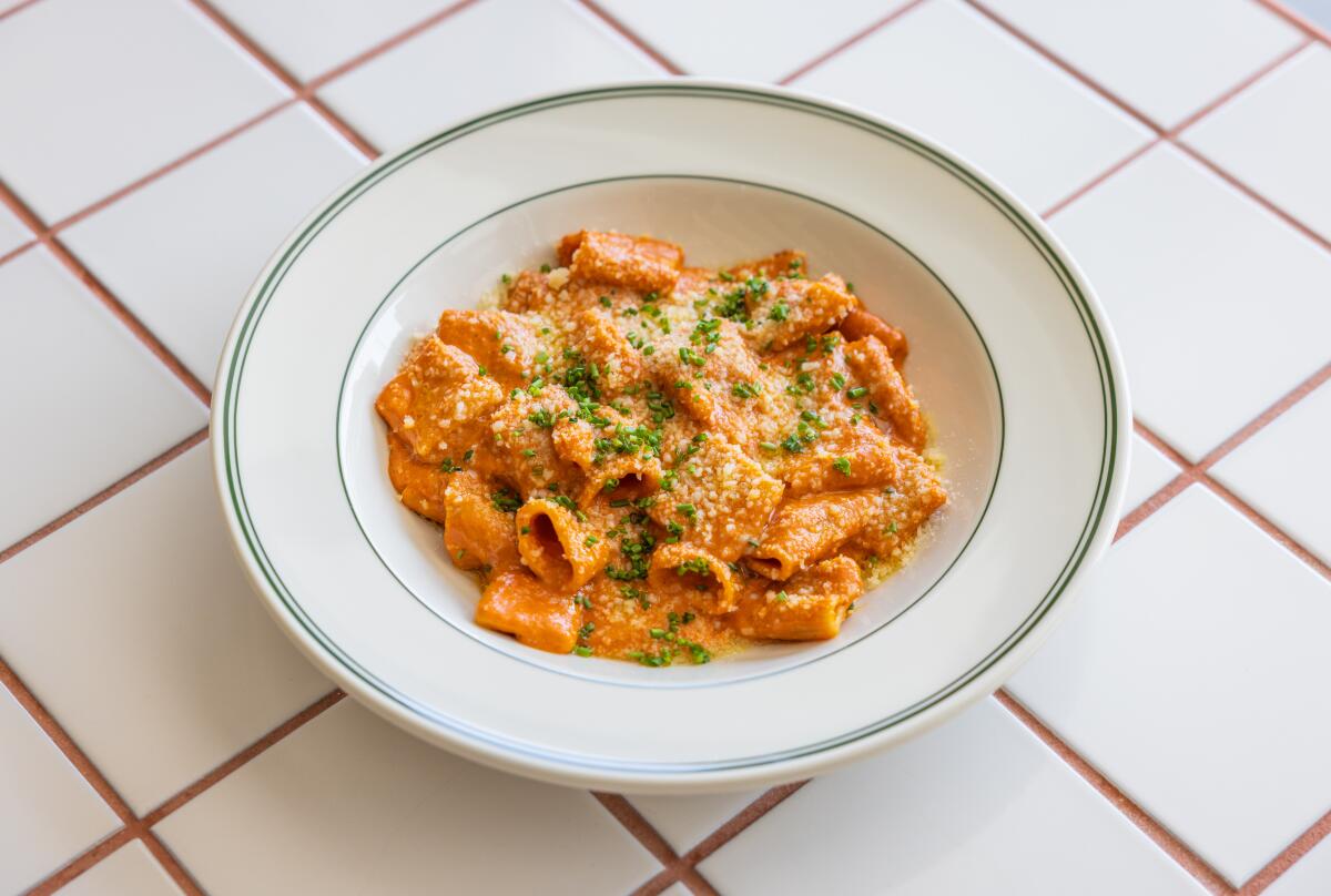 A bowl of rigatoni in a pink sauce.