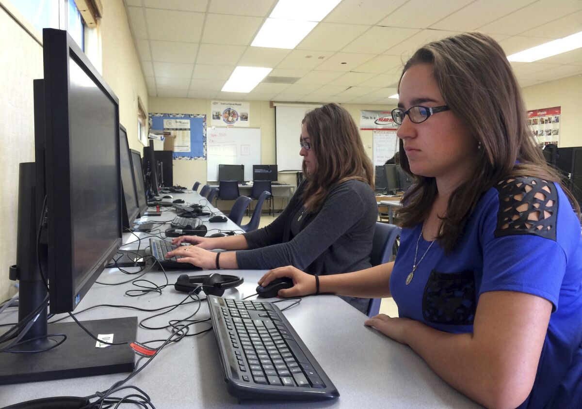 Supporters of ed-tech say it not only enhances traditional learning experiences within the classroom, but gives people the freedom to learn wherever they want, however they want. Above, Leticia Fonseca, 16, center, and her twin sister, Sylvia Fonseca, work in the computer lab at Cuyama Valley High School in New Cuyama, Calif.