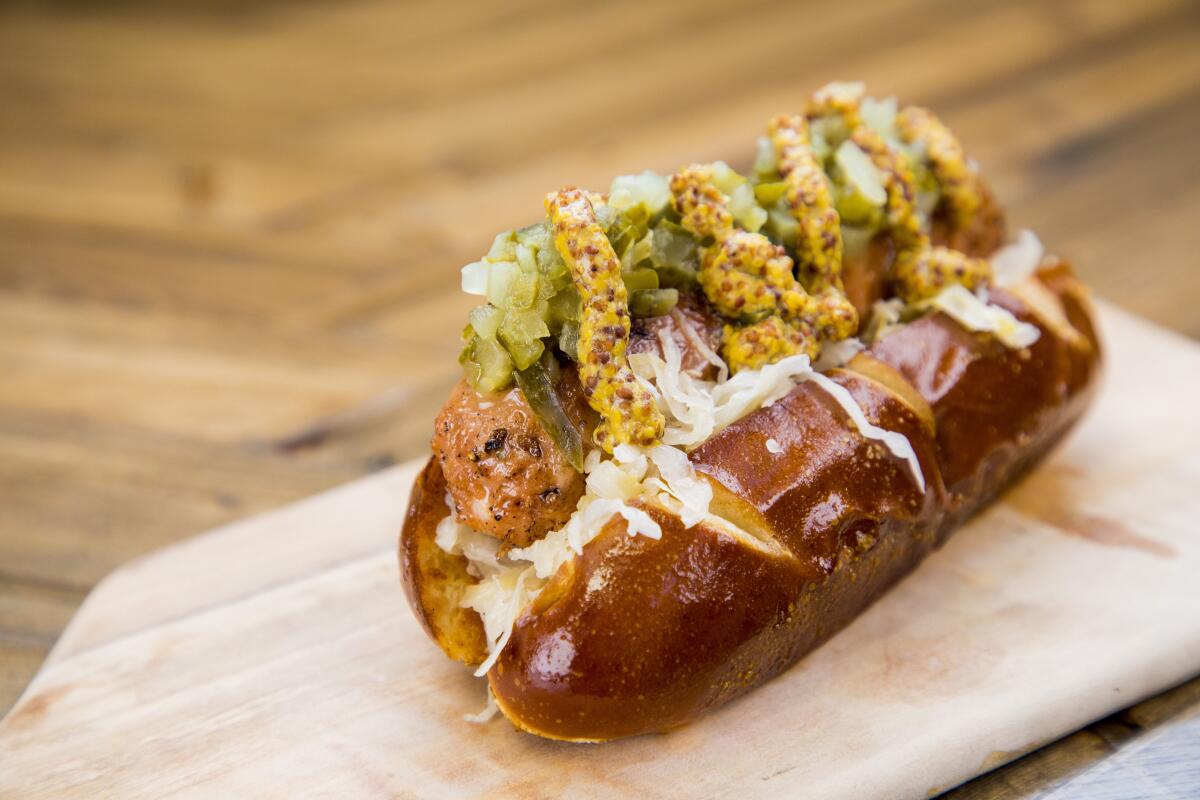 A plant-based bratwurst in a bun, topped with mustard and relish.