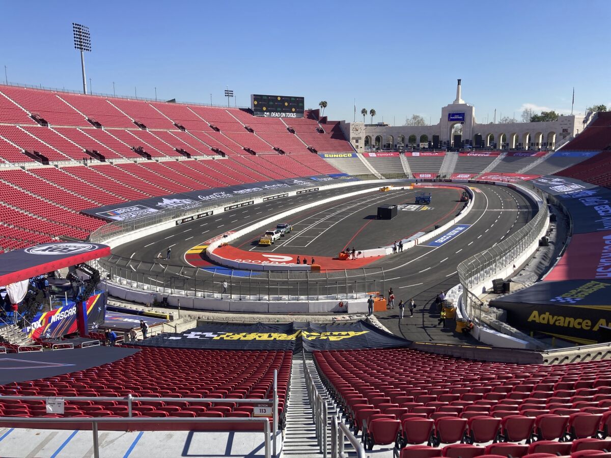 A temporary auto racing track is shown inside the Coliseum ahead of a NASCAR exhibition race in Los Angeles, Friday, Feb. 4, 2022. NASCAR is hitting Los Angeles a week ahead of the Super Bowl, grabbing the spotlight with its wildest idea yet: The Clash, the unofficial season-opening, stock-car version of the Pro Bowl, will run at the iconic Coliseum in a made-for-Fox Sports spectacular. (AP Photo/Jenna Fryer)