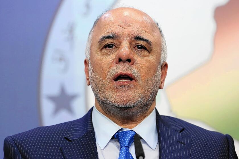 Haider Abadi speaks to reporters in Baghdad in July 15.