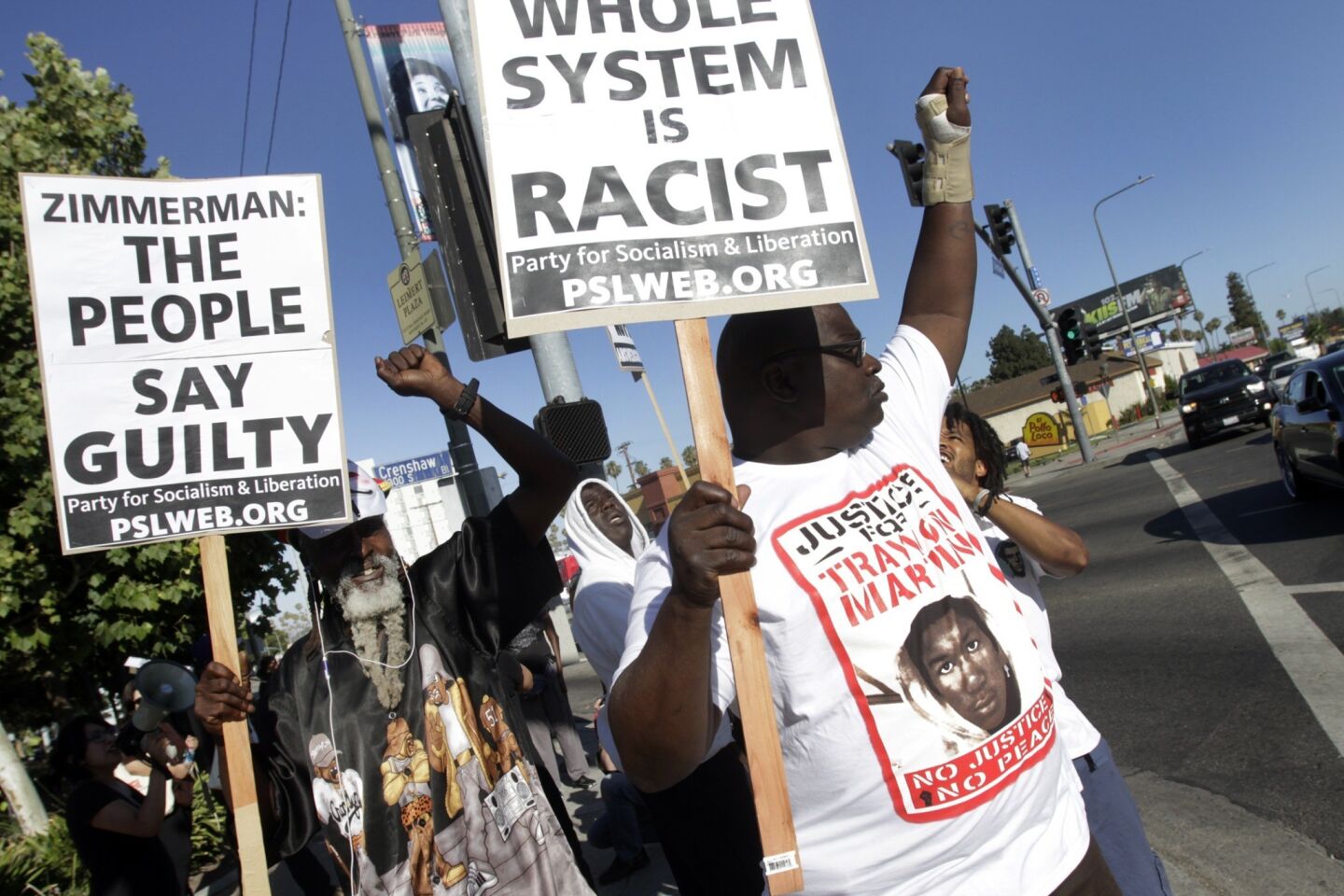 Protesters marching on the sidewalk on Crenshaw Boulevard on Monday against the not-guilty verdict of George Zimmerman.