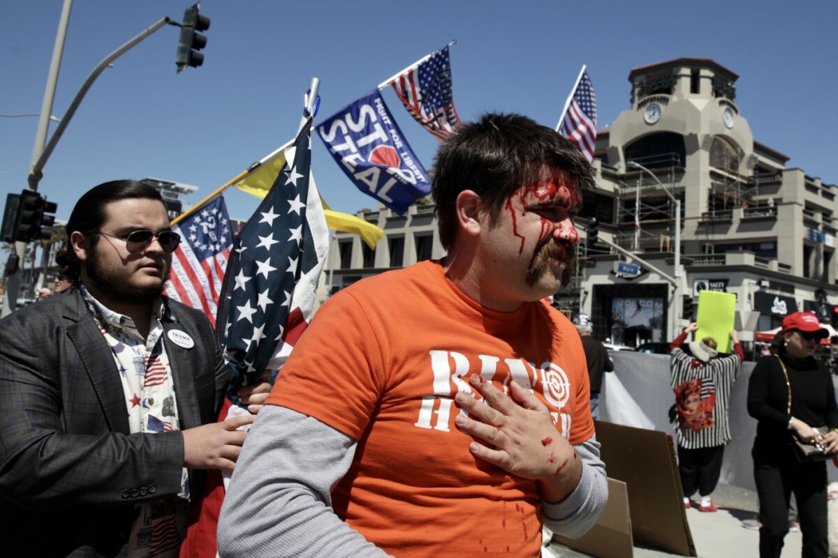 Protesters got into a scuffle in Huntington Beach during a pro-Trump rally on Saturday, 