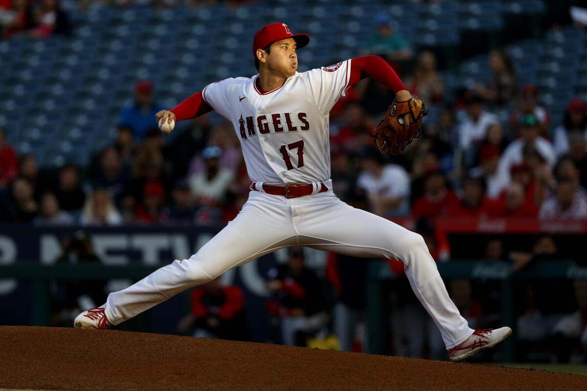 Angels’ Shohei Ohtani delivers a pitch against the Cleveland Guardians at Angel Stadium of Anaheim.