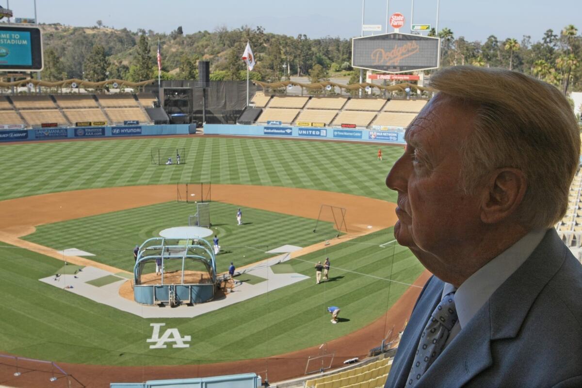 Vin Scully, shown at Dodger Stadium last July, says he won't miss the season opener as he did a year ago with a cold.