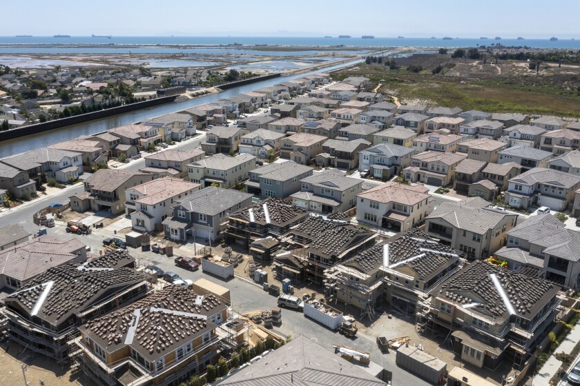 HUNTINGTON BEACH, CA - AUGUST 9: An aerial view of workers building new homes at Parkside Estates in Huntington Beach.