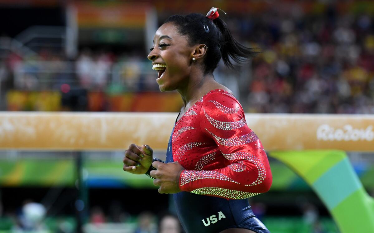 U.S. gymnast Simone Biles is all smiles after scoring 15.633 on the beam during qualification at the Rio Olympics.