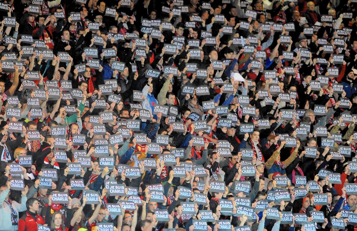 Guingamp soccer fans hold signs reading "Je suis Charlie" (I am Charlie) to pay tribute to the victims of the Charlie Hebdo attack in France.