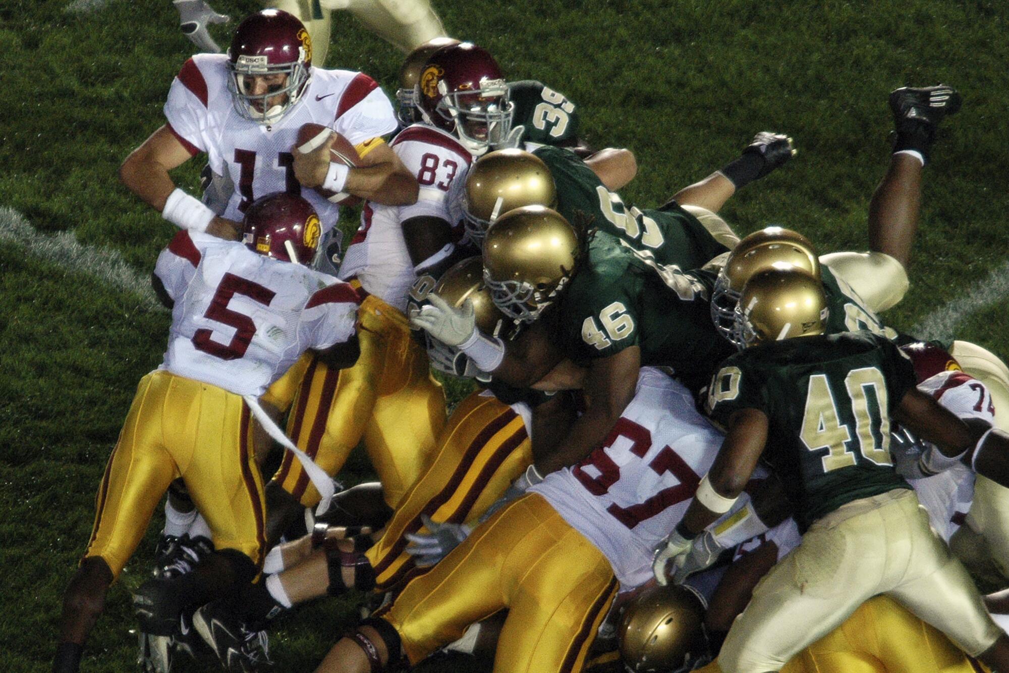USC running back Reggie Bush pushes quarterback Matt Leinhart into the end zone to seal a win over Notre Dame in 2005.