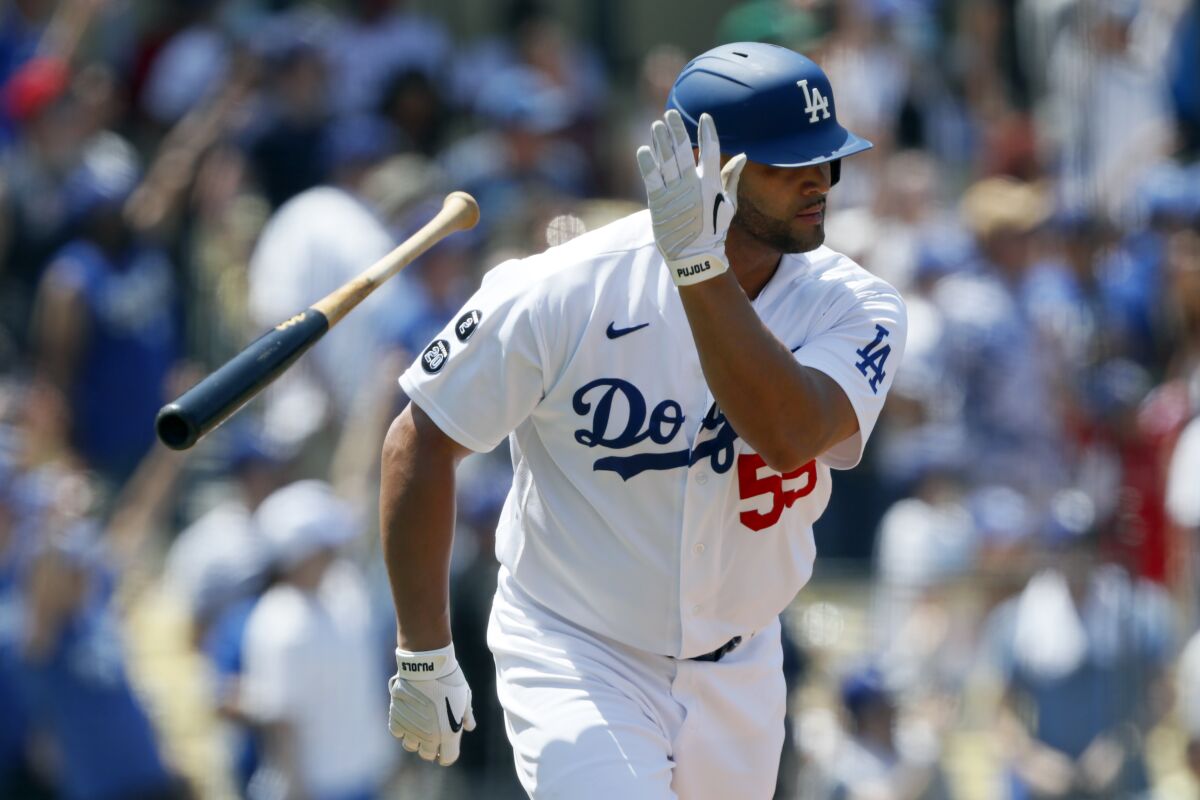 Los Angeles Dodgers' Albert Pujols throws his bat after hitting a two-run home run against the Los Angeles Angels during the second inning of a baseball game in Los Angeles, Sunday, Aug. 8, 2021. (AP Photo/Alex Gallardo)