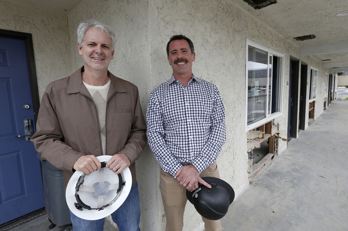 Mercy House CEO Larry Haynes and CDP President Kyle Paine, at a Costa Mesa Motel 6 being rebuilt into affordable housing.