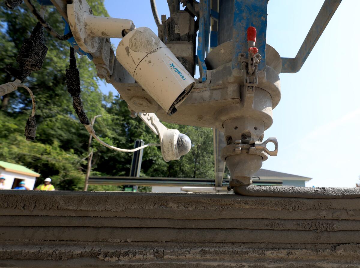 A 3-D-printing machine operates outdoors