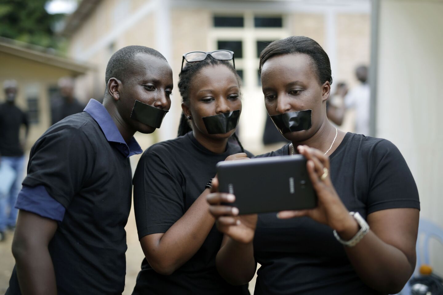 Journalists with tape on their mouths gather May 3 to honor World Press Freedom Day in Bujumbura. In the wake of demonstrations protesting against the move by President Pierre Nkurunziza to seek a third term, the government shut down access to some social networks and closed a private radio station.