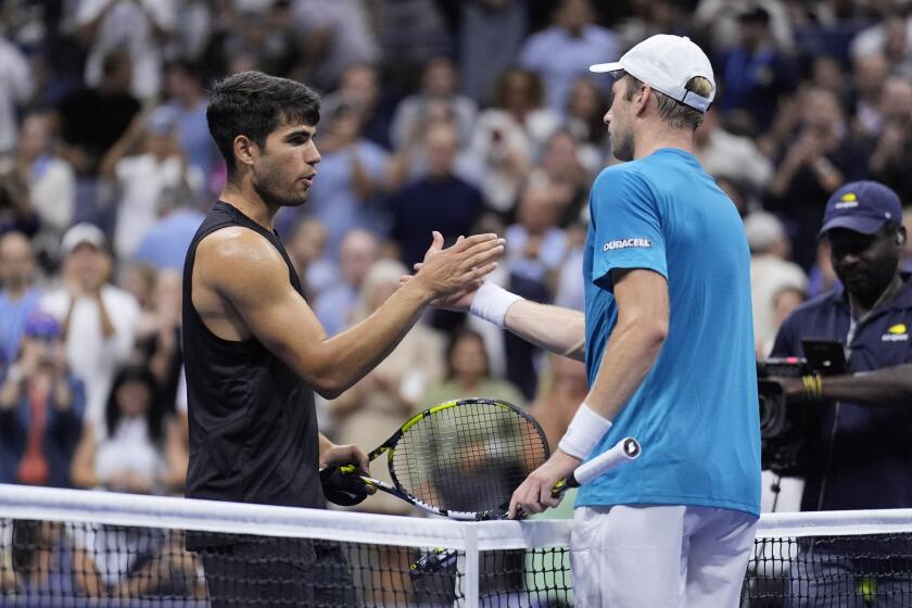 Botic van De Zandschulp, right, of the Netherlands, greets Carlos Alcaraz, of Spain.