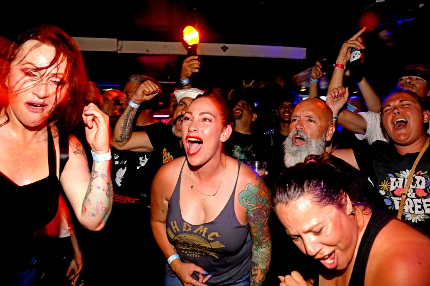 HUNTINGTON BEACH, CA - JUNE 13: Fans mosh to the song "Bro Hymn" by the band Pennywise, sung by karaoke singers at Punk Rock Karaoke at Gallagher's Pub HB on Sunday, June 13, 2021 in Huntington Beach, CA. Since 1996 Punk Rock Karaoke band members play live music while aficionados karaoke to selected songs. Punk Rock Karaoke band members; Greg Hetson (Bad Religion, Circle Jerks): Guitar-Vocals, Stan Lee (The Dickies): Guitar, Randy Bradbury (Pennywise): Bass-Vocals and Darrin Pfeiffer (Goldfinger) Drums-Vocals. (Gary Coronado / Los Angeles Times)