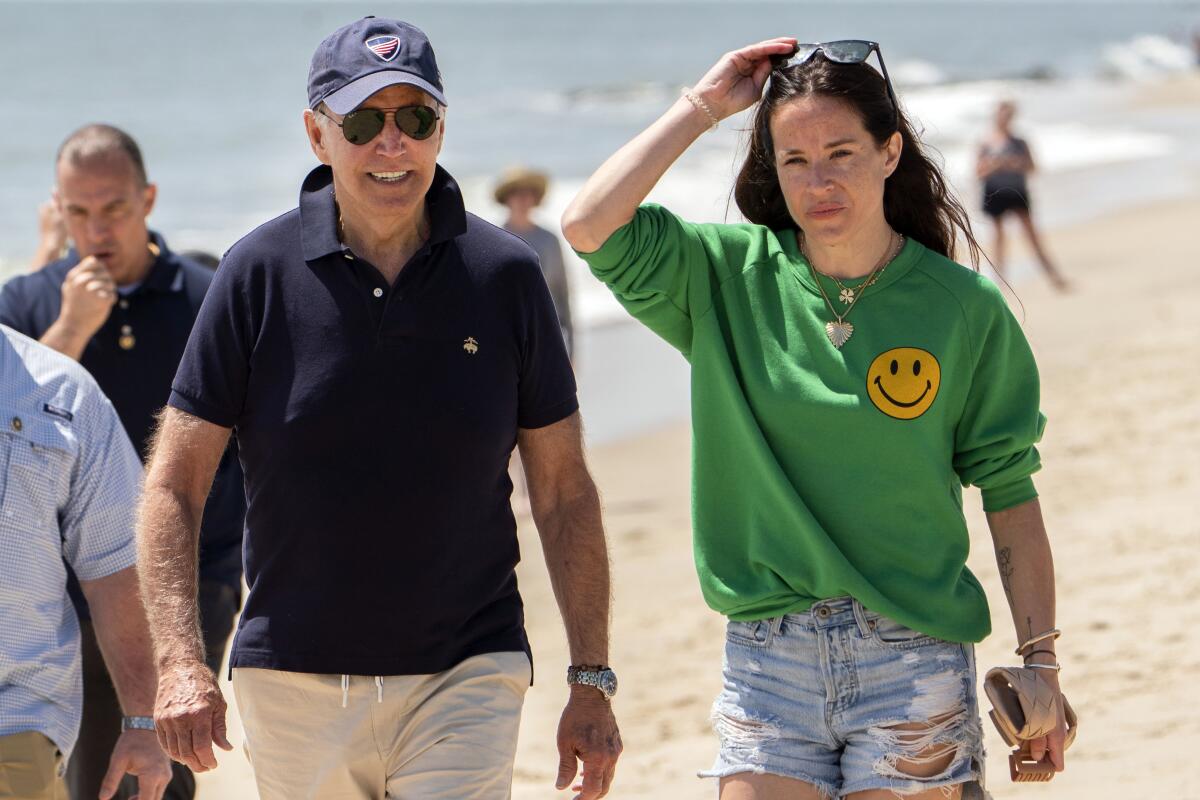 President Biden walks on the beach with daughter Ashley Biden