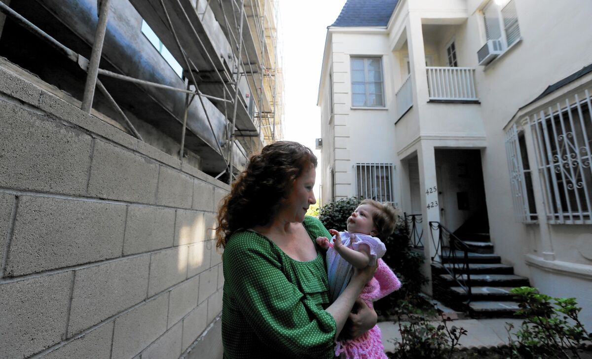 Dee Ann Newkirk and her newborn daughter live in a fourplex that was purchased last year.