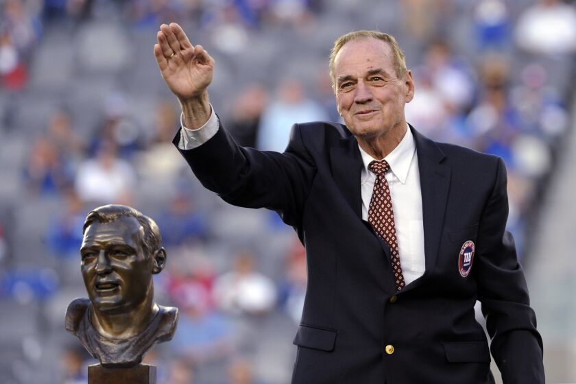 Sam Huff waves to fans as he stands behind his Hall of Fame bust at halftime of a Giants game Sept. 15, 2013.